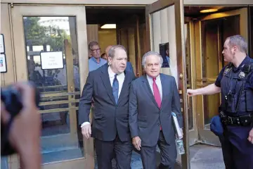  ?? — AFP photo ?? Harvey Weinstein (Left) departs with his lawyer Benjamin Brafman following a court appearance at Manhattan Criminal Court on July 9, 2018 in New York City. Weinstein, who was previously indicted on charges involving two women, is facing three new felony sex crimes against a third woman.