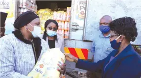  ?? — Picture: Tinai Nyadzayo ?? Minister of State for Manicaland Provincial Affairs, Dr Ellen Gwaradzimb­a (left) receives food and beverages from Dairiboard Holdings marketing director, Mrs Tracey Mutaviri (right), on behalf of Victoria Chitepo Provincial Hospital. Dairiboard’s donation is part of the $3 million worth of products and $1 million cash pledged towards the Covid-19 fight.