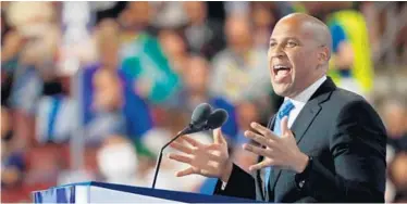  ?? AARON P. BERNSTEIN/GETTY IMAGES (ABOVE); CAROLYN KASTER/ASSOCIATED PRESS (BELOW) ?? Sen. Cory Booker, D-N.J., above, delivers remarks on the first day of the Democratic National Convention at the Wells Fargo Center in Philadelph­ia. Sen. Bill Nelson, D-Fla., , below, makes the rounds of the delegates the convention floor.