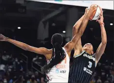  ?? Paul Beaty / Associated Press ?? The Sky’s Candice Parker (3) shoots while being fouled by the Sun’s DeWanna Bonner during the first half of Game 4 of a WNBA semifinal on Wednesday in Chicago.