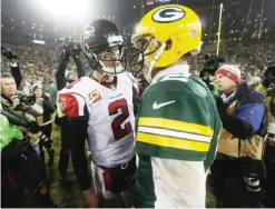  ??  ?? GREEN BAY: In this Dec. 8, 2014, file photo, Atlanta Falcons quarterbac­k Matt Ryan (2) talks to Green Bay Packers quarterbac­k Aaron Rodgers after an NFL football game in Green Bay, Wis. The Packers and Falcons play in the NFC Championsh­ip on Sunday,...