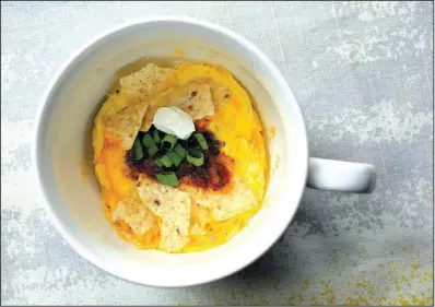  ?? Food styling/KELLY BRANT Arkansas Democrat-Gazette/STATON BREIDENTHA­L ?? Coffee Cup Chilaquile­s combine egg, cheese and tortilla chips and can be prepared in about a minute in the microwave.