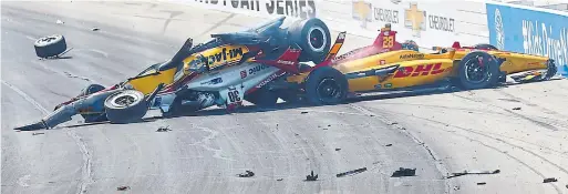  ?? RICH GRAESSLE GETTY IMAGES ?? The car of Takuma Sato, who touched off a multi-car crash on the first lap, landed upside down on Ryan Hunter-Reay’s Honda. Both drivers walked away unhurt.