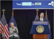  ?? DARREN MCGEE — OFFICE OF GOVERNOR ANDREW M. CUOMO VIA AP ?? In this file photo provided by the Office of Governor Andrew M. Cuomo, Hillary Clinton applauds as Gov. Cuomo speaks from the podium at LaGuardia Community College in the Queens borough of New York during a ceremonial bill signing of the a first-in-the...