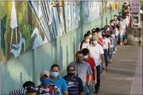  ?? ANGEL DEJESUS — THE ASSOCIATED PRESS ?? Voters line up at a polling station during a presidenti­al runoff election in Guayaquil, Ecuador, Sunday, April 11, 2021.