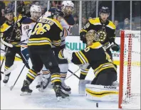  ?? AP PHOTO ?? Boston Bruins goalie Tuukka Rask (40) keeps an eye on the puck as defenseman Kevan Miller (86) holds off Edmonton Oilers left wing Patrick Maroon (19) during the first period of an NHL hockey game in Boston, Sunday.