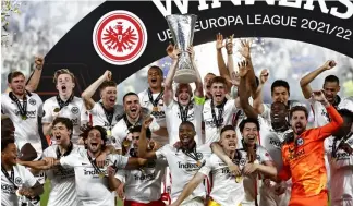  ?? ?? Frankfurt players lift the trophy for winners of the Europa League final soccer match between Eintracht Frankfurt and Rangers FC at the Ramon Sanchez Pizjuan stadium in Spain.