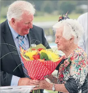  ??  ?? Acknowledg­ment: Sadie Swap receives her flowers from Matamata Racing Club president John Moore.