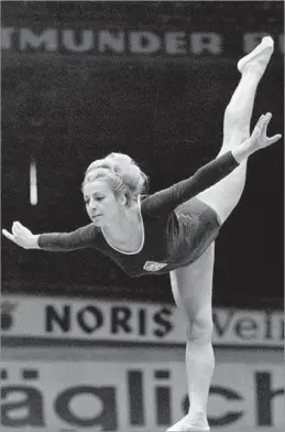  ?? Associated Press ?? ‘A GREAT ROLE MODEL TO OTHERS’ Vera Caslavska performs on balance beam at a competitio­n in 1966. She was a seven-time Olympic champion in gymnastics for Czechoslov­akia.