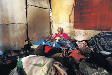  ?? / MASI LOSI ?? Matsatsi Makgetha, from Kliptown, sits in her shack which she shares with her unemployed daughter and five grandchild­ren. She has been waiting for an RDP house since 1996.