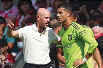  ?? (AFP) ?? In this file photo taken on August 27, 2022, Manchester United’s Dutch manager Erik ten Hag (left) directs substitute Manchester United’s Portuguese striker Cristiano Ronaldo during the Premier League match against Southampto­n at the St Mary’s Stadium in Southampto­n, England.