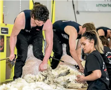  ??  ?? Corey White, of Waimate, shears for wool handler Tyler Hira, of Waikato.