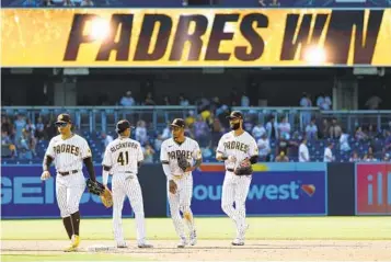  ?? K.C. ALFRED U-T ?? From left, Padres Trent Grisham, Sergio Alcantara, Jose Azocar and Nomar Mazara celebrate the 10-4 win.