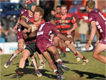  ?? Photos: Kevin Farmer ?? ON THE CHARGE: Hugh Sedger of Valleys Roosters is met with some strong defence from Danny Wassell (headgear) and Corey Blades.
