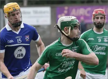  ??  ?? Gary Molloy of Naomh Eanna moves away from Podge Doran (Oylegate-Glenbrien) as Conor Hughes looks on.