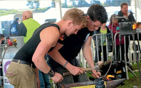  ??  ?? Callum Geddes and Kieran Dolan in the Maneline Kerckhaert Farrier and Blacksmith Championsh­ip at Equidays 2016.