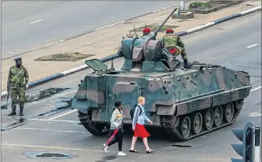  ?? Pictures: EPA / GETTY / REUTERS ?? Hated... ‘Gucci Grace’, left, was said to be detained, but the public and traffic mixed with troops in Harare yesterday