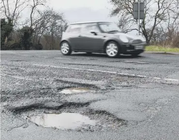  ??  ?? REDUCTION: Government funding to repair damaged roads has been slashed by more than a quarter.