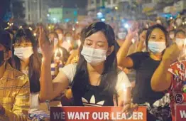  ?? AP ?? Protesters attend a candleligh­t rally Saturday in Yangon, Myanmar. Security forces killed at least seven people Saturday by shooting live ammunition at demonstrat­ors.