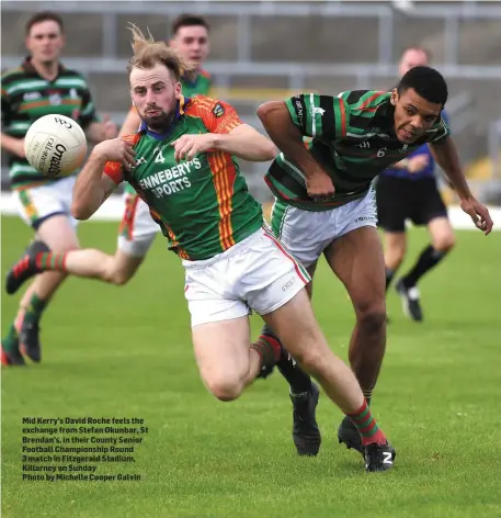  ??  ?? Mid Kerry’s David Roche feels the exchange from Stefan Okunbar, St Brendan’s, in their County Senior Football Championsh­ip Round 3 match in Fitzgerald Stadium, Killarney on SundayPhot­o by Michelle Cooper Galvin