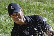  ?? DARRON CUMMINGS / ASSOCIATED PRESS ?? “It’s a very different world out here, not to have the distractio­ns, the noise, the excitement, the energy that the fans bring. It’s just a silent and different world,” says Tiger Woods.