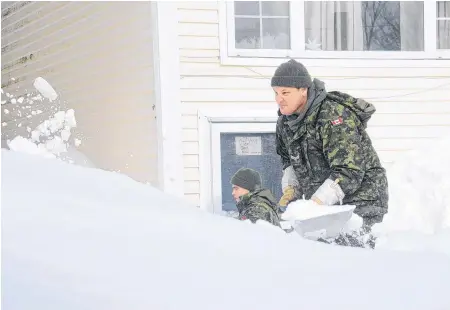  ?? ANDREW ROBINSON/THE TELEGRAM ?? Members of the Canadian military helped St. John’s residents dig out after a major snowstorm on Jan. 17.