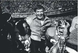  ?? Denver Post file ?? Coach Red Miller gets a ride off the field on the shoulders of players Billy Thompson, left, and Glenn Hyde on Jan. 1, 1978, after the Broncos beat the Oakland Raiders 20-17 in the AFC championsh­ip game at Mile High Stadium. The victory sent the...