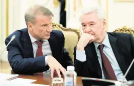  ?? DMITRY ASTAKHOV Sputnik via AP ?? The U.S. Department of Treasury has sanctioned Sberbank CEO Herman Gref, left, seen here last month with Moscow Mayor Sergei Sobyanin. The United States calls Gref, who was Lev Khasis’ boss, a close associate of Vladimir Putin.