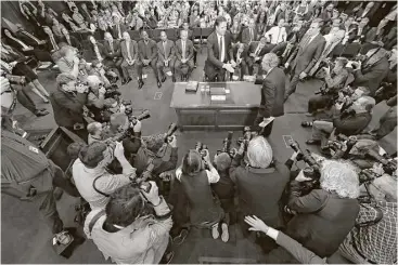  ?? Andrew Harnik / Associated Press ?? Former FBI director James Comey, center standing, kept people’s attention with a flowing, narrative-like testimony at the Senate Intelligen­ce Committee hearing on Capitol Hill, where he appeared to win viewer support.