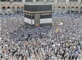  ??  ?? Muslim pilgrims walk around the Kaaba in the Grand Mosque in Mecca, Saudi Arabia, on Friday. The Islamic hajj draws millions of visitors, making it the largest yearly gathering of people in the world. PHOTOS BY DAR YASIN/AP