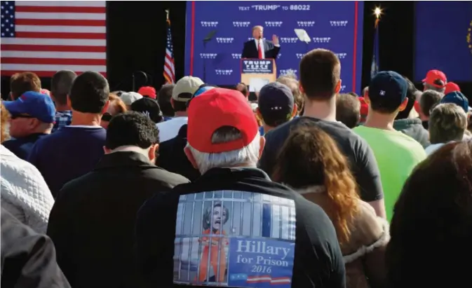  ??  ?? PORTSMOUTH: A supporter of Republican presidenti­al candidate Donald Trump wears a shirt that reads ‘Hillary for Prison’ as Trump speaks at an event. —AFP