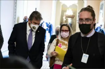  ?? Al Drago/The New York Times ?? Sen. Joe Manchin, D-W.Va., left, and Sen. Kyrsten Sinema, D-Ariz., depart a Democratic policy luncheon at the Capitol in Washington on Tuesday. They have not explicitly committed to supporting the president’s domestic agenda that passed the House on Friday.