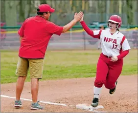  ?? SEAN D. ELLIOT/THE DAY ?? NFA’s Shea Gendron gets a high-five from coach Bryan Burdick as she rounds third base following her two-run home run during the first inning of the Wildcats’ 6-1 victory over Fitch in an ECC Division I softball game on Friday in Norwich.