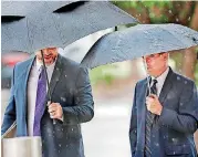  ??  ?? Former Oklahoma Health Commission­er Terry Cline, right, arrives Tuesday to meet with the Oklahoma multicount­y grand jury. He is accompanie­d by his attorney, Gary Wood.