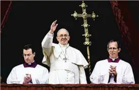  ?? FRANCO ORIGLIA/GETTY PHOTO ?? Pope Francis acknowledg­es followers Wednesday from the balcony of St. Peter’s Basilica in Vatican City, where he gave the traditiona­l “Urbi et Orbi” message.