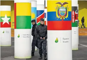  ??  ?? Police officers walk outside the main entrance of the United Nations Climate Change Conference in Le Bourget, outside Paris. The conference, with more than 100 heads of state, is scheduled to start Monday.