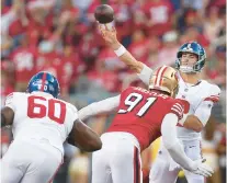  ?? JED JACOBSOHN/AP ?? Giants quarterbac­k Daniel Jones, right, passes as 49ers defensive end Arik Armstead applies pressure during the first half in Santa Clara, Calif. on Sept. 21.