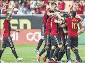  ?? MIGUEL MARTINEZ/MUNDO HISPANICO ?? Atlanta United players celebrate with Hector Villalba after the second goal Sunday against NYCFC at Bobby Dodd Stadium.