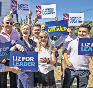  ?? ?? Liz Truss joins a group of enthusiast­ic party members in the village of Marden, Kent, where she was campaignin­g yesterday