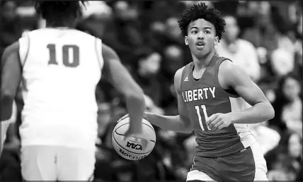  ?? STEVE MARCUS ?? Liberty’s Dedan Thomas (11) takes the ball upcourt during the Big City Showdown basketball tournament Jan. 21 at Cox Pavilion at UNLV. Thomas, the prized UNLV prospect who averaged 22 points and five rebounds per game during the regular season, was selected by coaches as the Most Valuable Player in Class 5A. Durango’s Tylen Riley (10) defends at left.