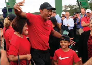  ?? TANNEN MAURY EPA ?? TIGER WOODS celebrates with family after winning the 2019 Masters at Augusta National yesterday. |