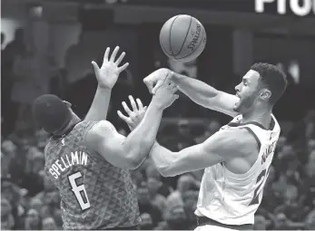  ?? AP PHOTO/TONY DEJAK ?? The Cleveland Cavaliers’ Larry Nance Jr., right, is fouled by the Atlanta Hawks’ Omari Spellman during their game Tuesday in Cleveland. The Cavaliers won 136-114.