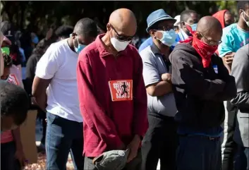  ?? AP Photo/John Bazemore ?? People pray during a rally to protest the shooting of Ahmaud Arbery, on Friday in Brunswick Ga.