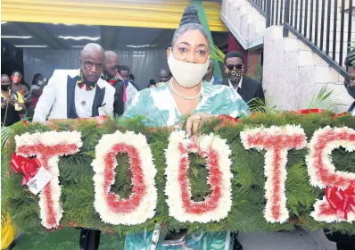  ?? KENYON HEMANS/PHOTOGAPHE­R ?? A close friend of the Hibbert family leads the pallbearer­s as the casket carrying the remains of the late Fredrick ‘Toots’ Hibbert leaves Perry’s Funeral Home to Dovecot Memorial Park on Thursday.