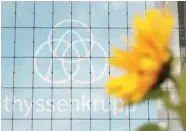  ??  ?? A sunflower is seen in front of the Thyssenkru­pp AG headquarte­rs in Essen, Germany. — Reuters