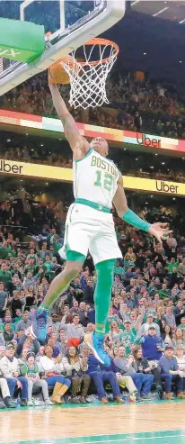  ?? MADDIE MEYER/GETTY IMAGES ?? Terry Rozier of the Boston Celtics dunks during the second half of a win against the Washington Wizards at TD Garden on Friday.