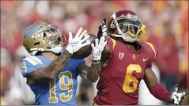  ?? AP file photo ?? UCLA running back Kazmeir Allen makes a touchdown catch as Southern California cornerback Isaac Taylor-Stuart defends during a game on Nov. 20. On Thursday, the Big Ten voted to add both Los Angeles schools as conference members in 2024.