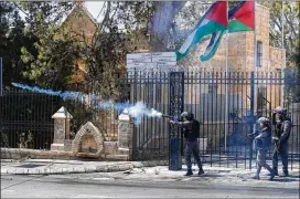  ?? NASSER SHIYOUKHI / ASSOCIATED PRESS ?? Israeli border police shoot tear gas at Palestinia­n protesters in the West Bank city of Bethlehem on Saturday. Israel’s chief military spokesman says if violence drags on along the Gaza border, Israel will widen its reaction to hit militants behind it.