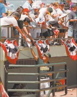  ?? Review-Journal file ?? Fans seek autographs at an Oakland A’s regular season game at Cashman Field in April 1996.