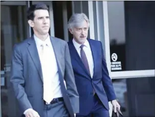  ?? STEPHEN LAM/GETTY IMAGES/AFP ?? Waymo CEO John Krafcik (right) exits Phillip Burton Federal Building after day one of the trial between Waymo and Uber Technologi­es on Monday in San Francisco, California.